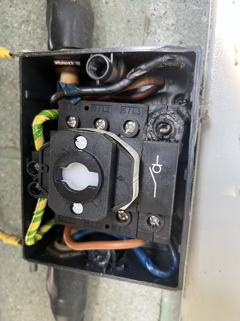 Burnt neutral terminal discovered inside an outdoor air conditioning unit rotary isolator