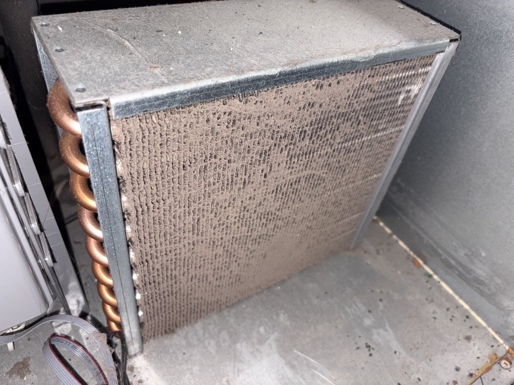 Refrigerated cabinet condenser coil blocked with dust